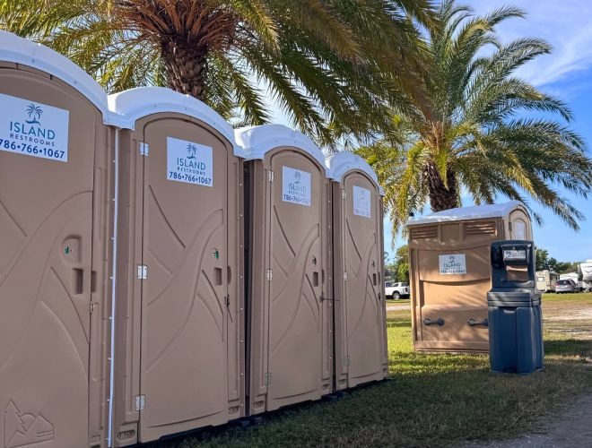 Row of clean porta potties at an outdoor event in South Florida
