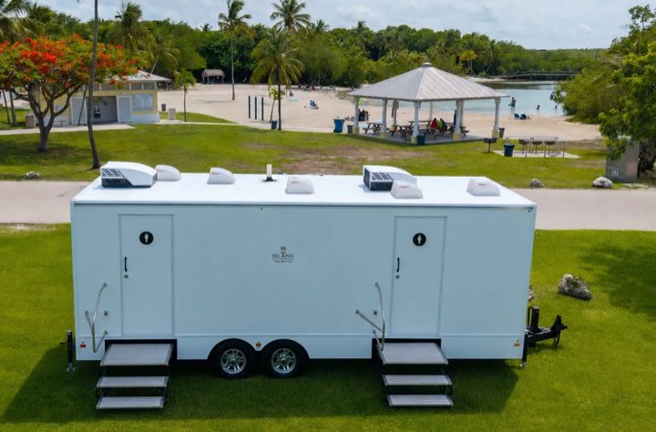 Island Restrooms 10 Station Signature restroom trailer set up at an outdoor park event